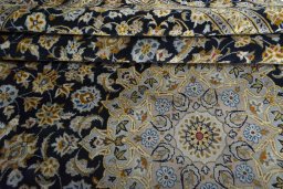 Close-up detail of 2000s Kashan rug from Iran / Persia showing Wool weave