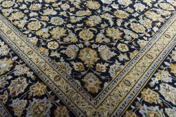 Close-up detail of 2000s Kashan rug from Iran / Persia showing Wool weave