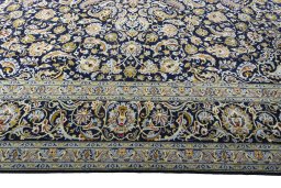 Corner detail of 2000s Kashan rug showing border pattern and Wool pile