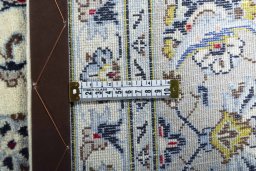 Backside of handmade New Kashan rug showing knot structure and weave density