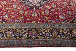 Corner detail of 2000s Kashan rug showing border pattern and Wool pile