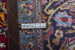Backside of handmade 2000s Kashan rug showing knot structure and weave density