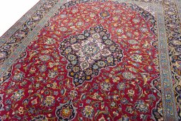 Backside of handmade 2000s Kashan rug showing knot structure and weave density