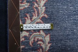 Corner detail of 2000s Kashan rug showing border pattern and Wool pile