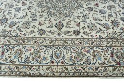 Corner detail of 2000s Kashan rug showing border pattern and Wool pile