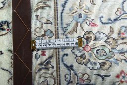 Backside of handmade 2000s Kashan rug showing knot structure and weave density