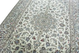Backside of handmade 2000s Kashan rug showing knot structure and weave density