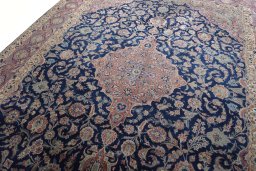 Backside of handmade 1930s Kashan rug showing knot structure and weave density