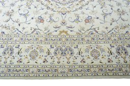 Corner detail of 2000s Kashan rug showing border pattern and Wool pile