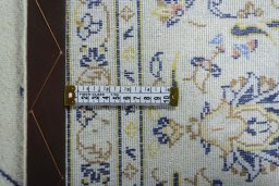 Backside of handmade 2000s Kashan rug showing knot structure and weave density
