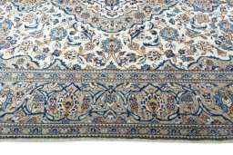 Corner detail of 2000s Kashan rug showing border pattern and Wool pile