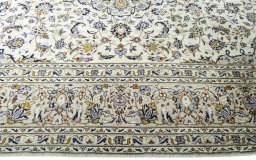 Corner detail of 2000s Kashan rug showing border pattern and Wool pile