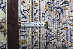 Backside of handmade 2000s Kashan rug showing knot structure and weave density