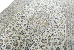 Backside of handmade 2000s Kashan rug showing knot structure and weave density