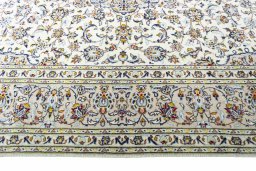 Corner detail of 2000s Kashan rug showing border pattern and Wool pile