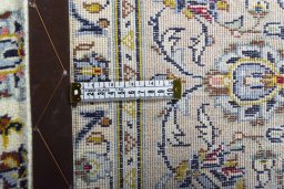 Backside of handmade 2000s Kashan rug showing knot structure and weave density