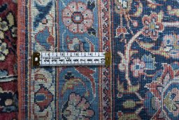 Backside of handmade 1930s Kashan rug showing knot structure and weave density