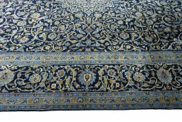 Corner detail of 2000s Kashan rug showing border pattern and Wool pile