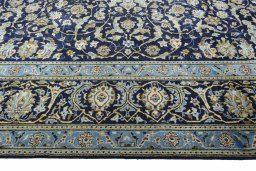 Corner detail of 2000s Kashan rug showing border pattern and Wool pile
