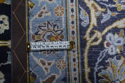 Backside of handmade 2000s Kashan rug showing knot structure and weave density
