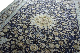 Backside of handmade 2000s Kashan rug showing knot structure and weave density