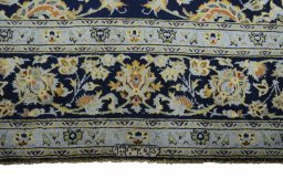 Corner detail of 2000s Kashan rug showing border pattern and Wool pile