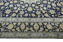 Close-up detail of 2000s Kashan rug from Iran / Persia showing Wool weave