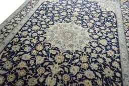 Backside of handmade 2000s Kashan rug showing knot structure and weave density