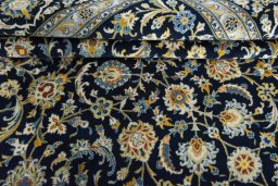 Close-up detail of 2000s Kashan rug from Iran / Persia showing Wool weave