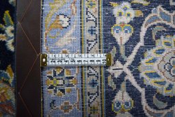 Backside of handmade 2000s Kashan rug showing knot structure and weave density