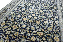 Backside of handmade 2000s Kashan rug showing knot structure and weave density