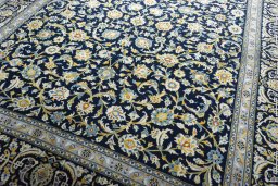 Close-up detail of 2000s Kashan rug from Iran / Persia showing Wool weave
