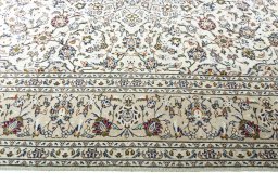 Corner detail of 2000s Kashan rug showing border pattern and Wool pile