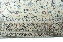 Corner detail of 2000s Kashan rug showing border pattern and Wool pile