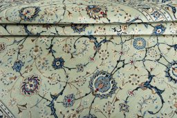 Backside of handmade 2000s Kashan rug showing knot structure and weave density