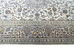 Corner detail of 2000s Kashan rug showing border pattern and Wool pile