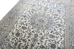 Backside of handmade 2000s Kashan rug showing knot structure and weave density