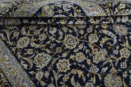 Close-up detail of 2000s Kashan rug from Iran / Persia showing Wool weave
