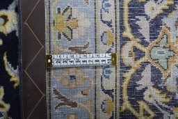 Backside of handmade 2000s Kashan rug showing knot structure and weave density