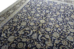 Backside of handmade 2000s Kashan rug showing knot structure and weave density