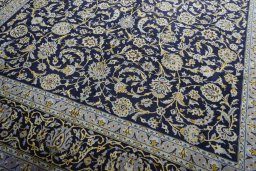Close-up detail of 2000s Kashan rug from Iran / Persia showing Wool weave