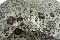 Backside of handmade 2000s Kashan rug showing knot structure and weave density