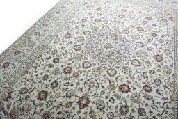 Backside of handmade 2000s Kashan rug showing knot structure and weave density