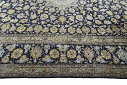 Corner detail of 2000s Kashan rug showing border pattern and Wool pile