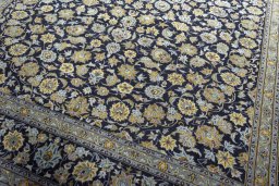 Close-up detail of 2000s Kashan rug from Iran / Persia showing Wool weave