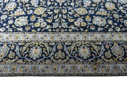Corner detail of 2000s Kashan rug showing border pattern and Wool pile