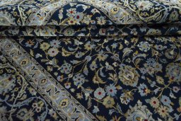 Close-up detail of 2000s Kashan rug from Iran / Persia showing Wool weave