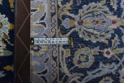 Backside of handmade 2000s Kashan rug showing knot structure and weave density