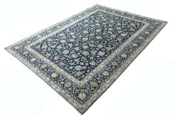 Corner detail of 2000s Kashan rug showing border pattern and Wool pile