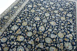 Backside of handmade 2000s Kashan rug showing knot structure and weave density